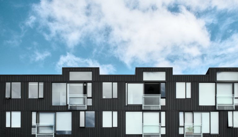 Moderne leiligheter med høye vinduer og arkitektisk byggutforming